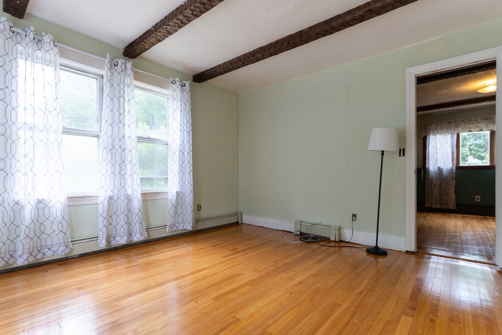 150 Framingham Road, Unit 2 Southborough, MA 01772 - Photo 10 of 20 a view of empty room with wooden floor and fan