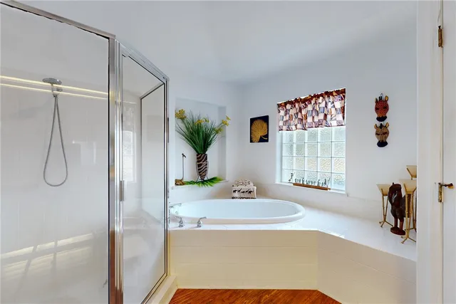 a spacious bathroom with a granite countertop sink and a shower
