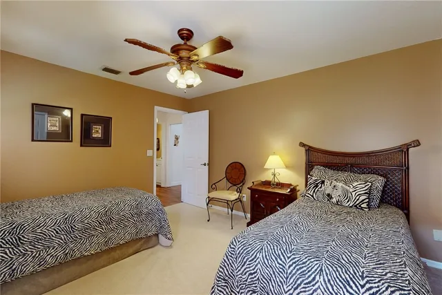 a bedroom with bed and a chandelier