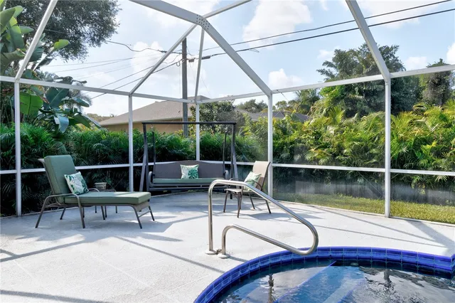 a view of a chair and tables in the patio