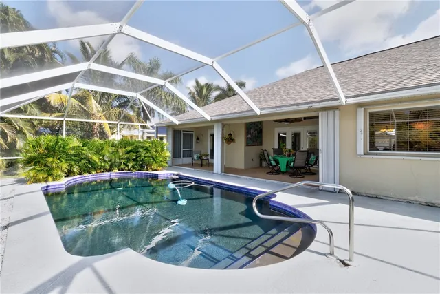 a view of a house with swimming pool and sitting area
