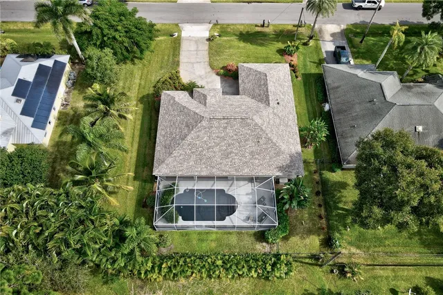 an aerial view of a house with a yard and potted plants