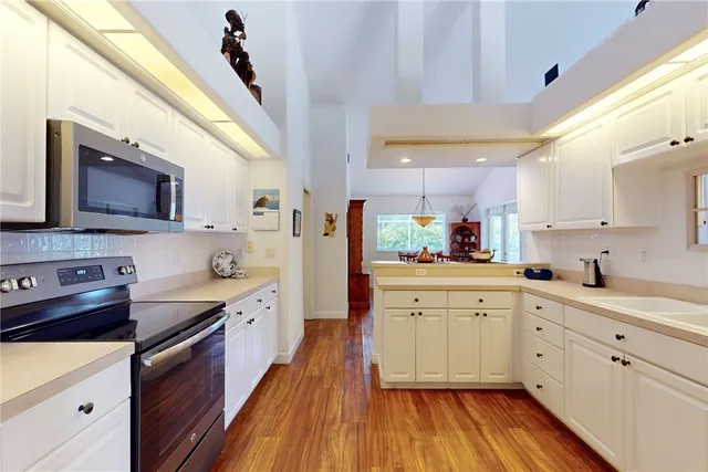 a kitchen with stainless steel appliances a stove sink and cabinets