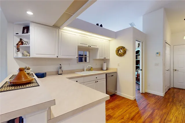 a kitchen with a refrigerator and cabinets