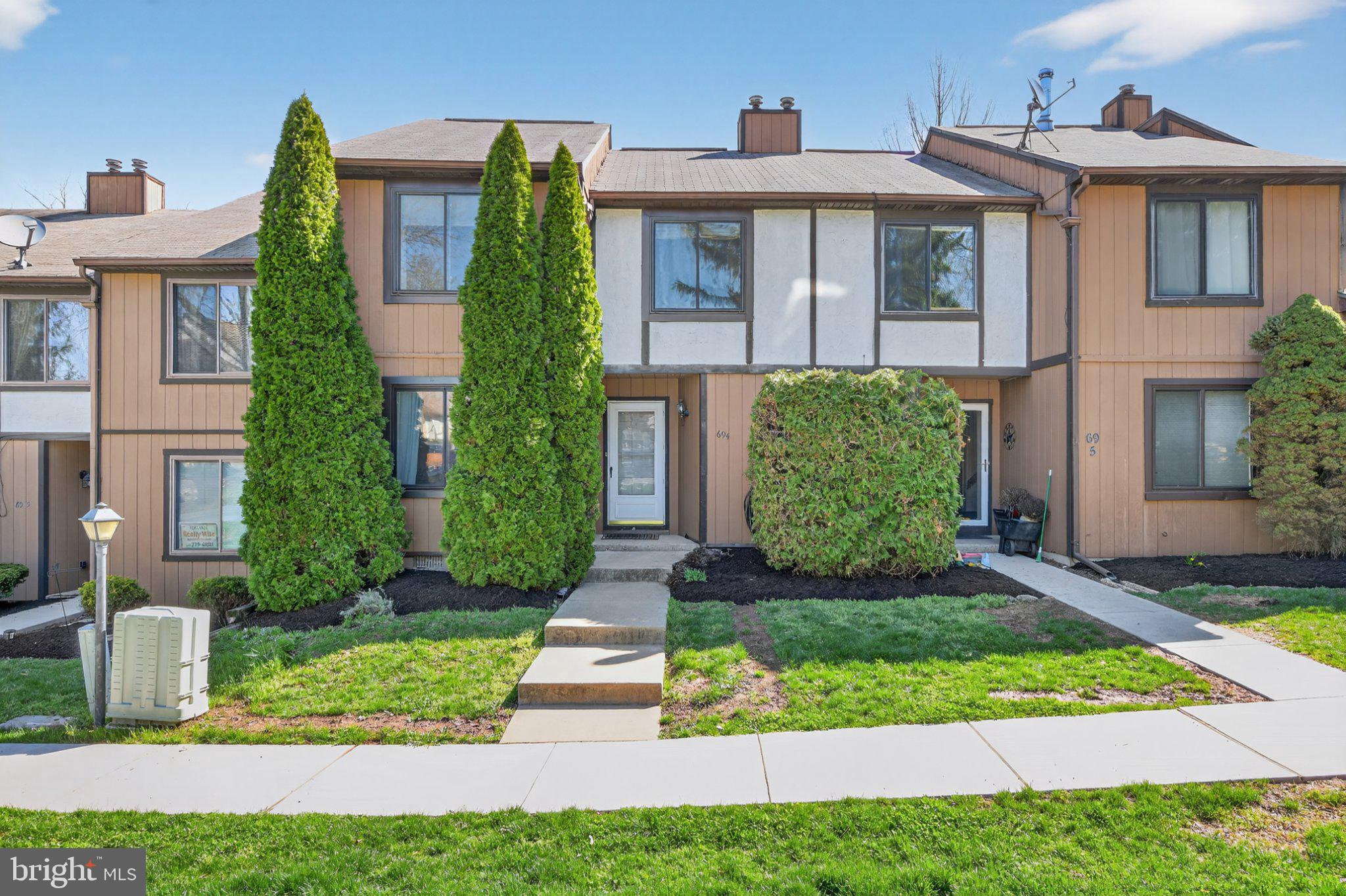 Charming townhouse with lush greenery.