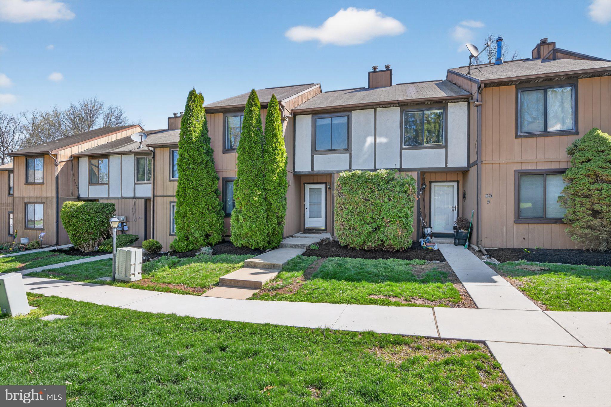 69-4 Azalea Way Reading, PA 19606 - Photo 2 of 34 Charming townhomes with lush greenery.