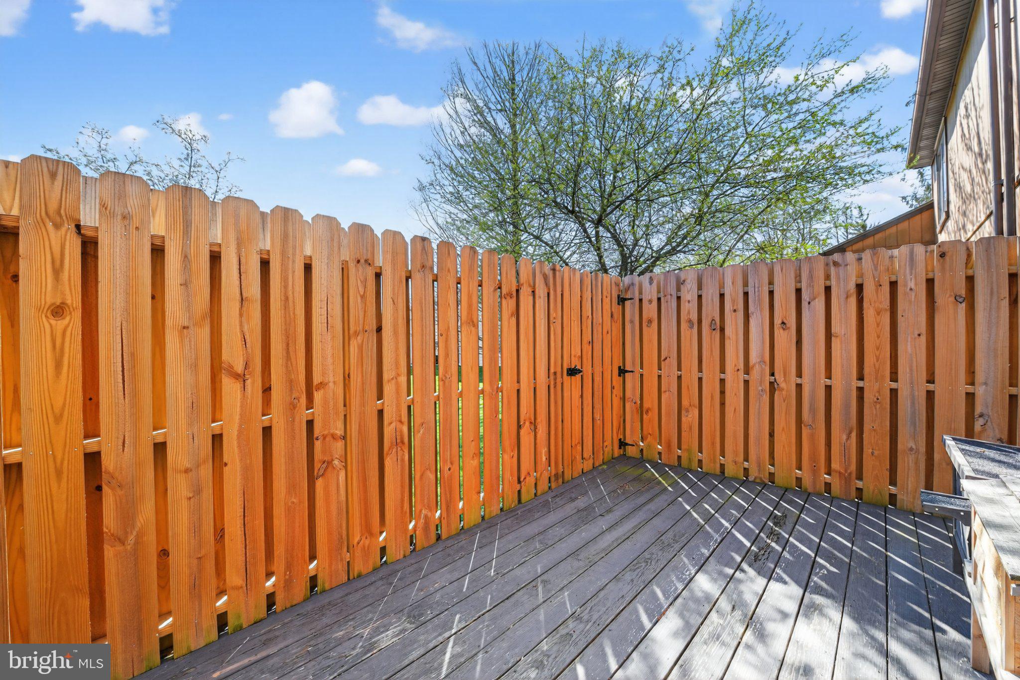 69-4 Azalea Way Reading, PA 19606 - Photo 30 of 34 Sunny corner retreat with wooden fence.