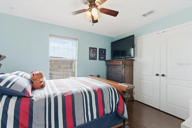 a bedroom with a bed and a television