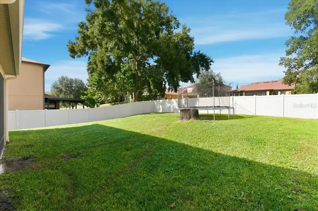 a view of a house with a backyard