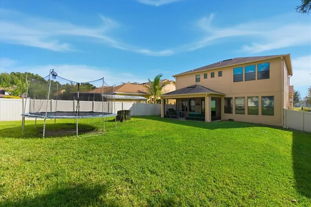 a view of an house with backyard and a garden