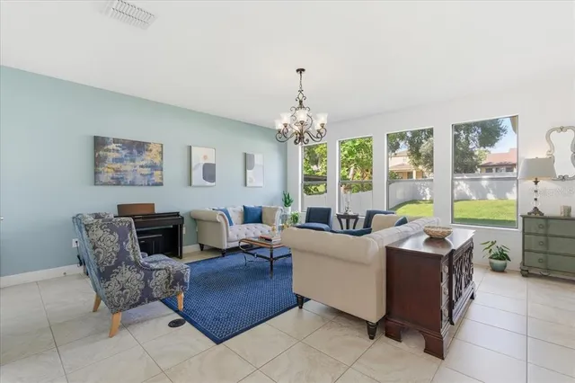 a living room with furniture and a chandelier