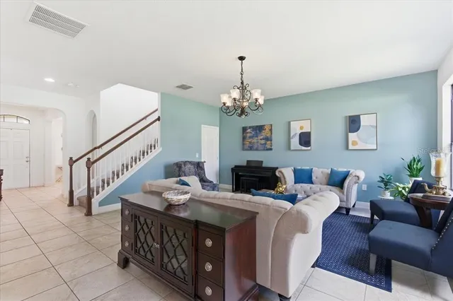 a living room with furniture and a chandelier