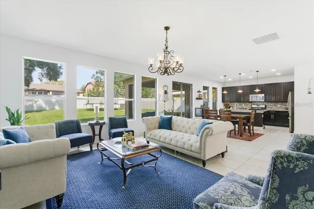 a living room with furniture and a chandelier