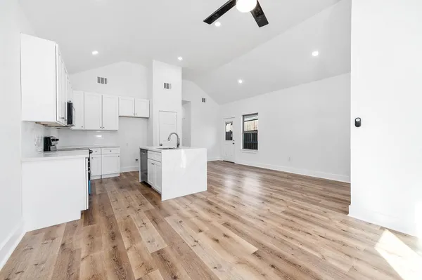 a view of kitchen with granite countertop cabinets and white appliances