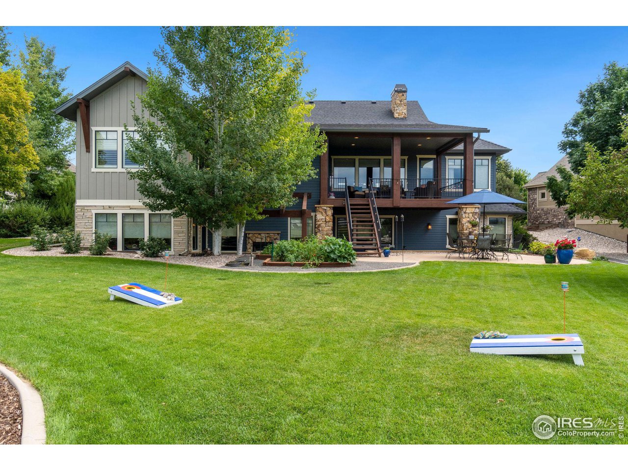 6568 Rookery Road Fort Collins, CO 80528 - Photo 4 of 16 a front view of a house with a yard table and chairs