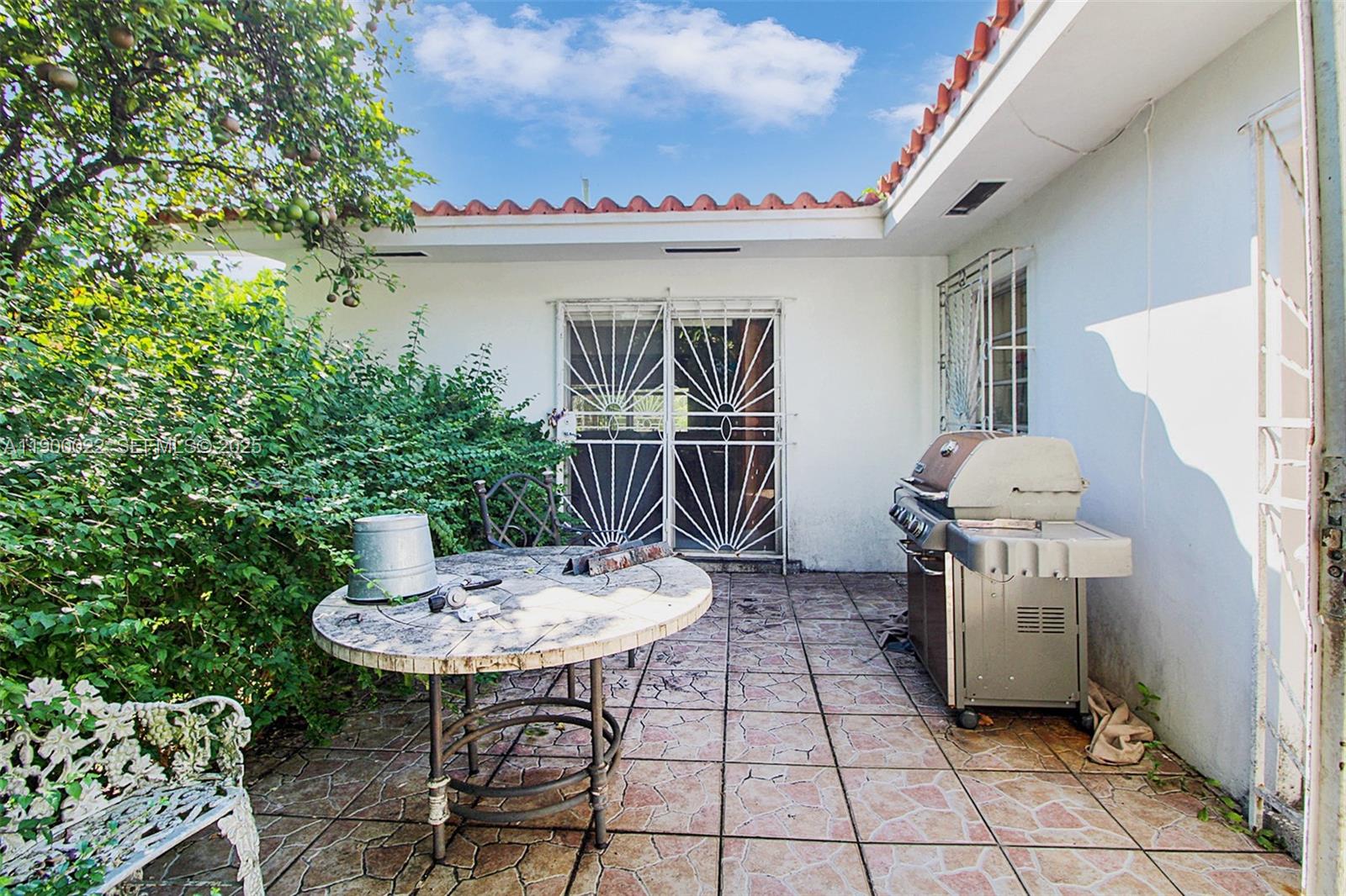 2711 Red Road Coral Gables, FL 33134 - Photo 14 of 33 a table and chairs in a patio