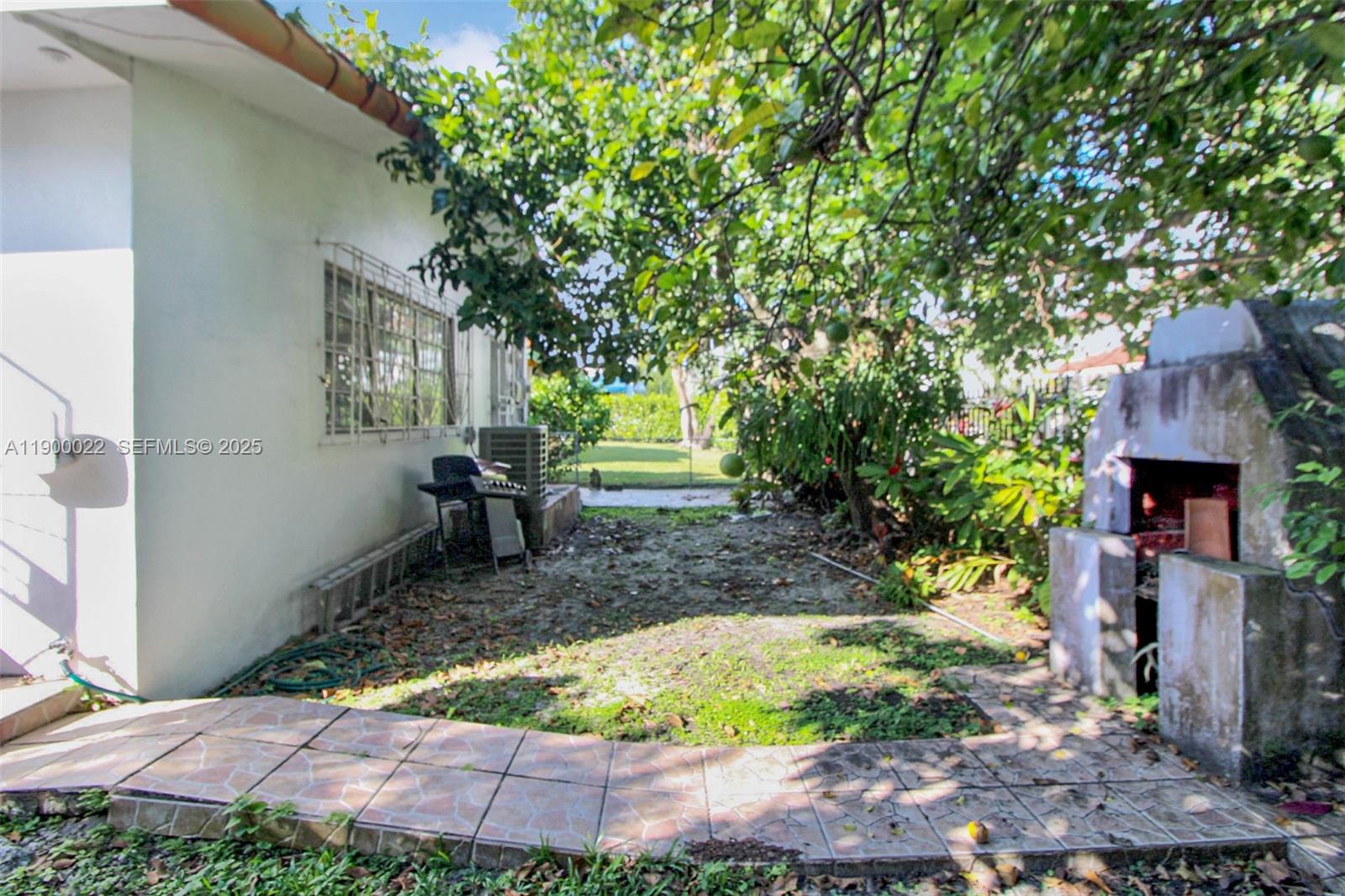 2711 Red Road Coral Gables, FL 33134 - Photo 15 of 33 a backyard of a house with yard and outdoor seating