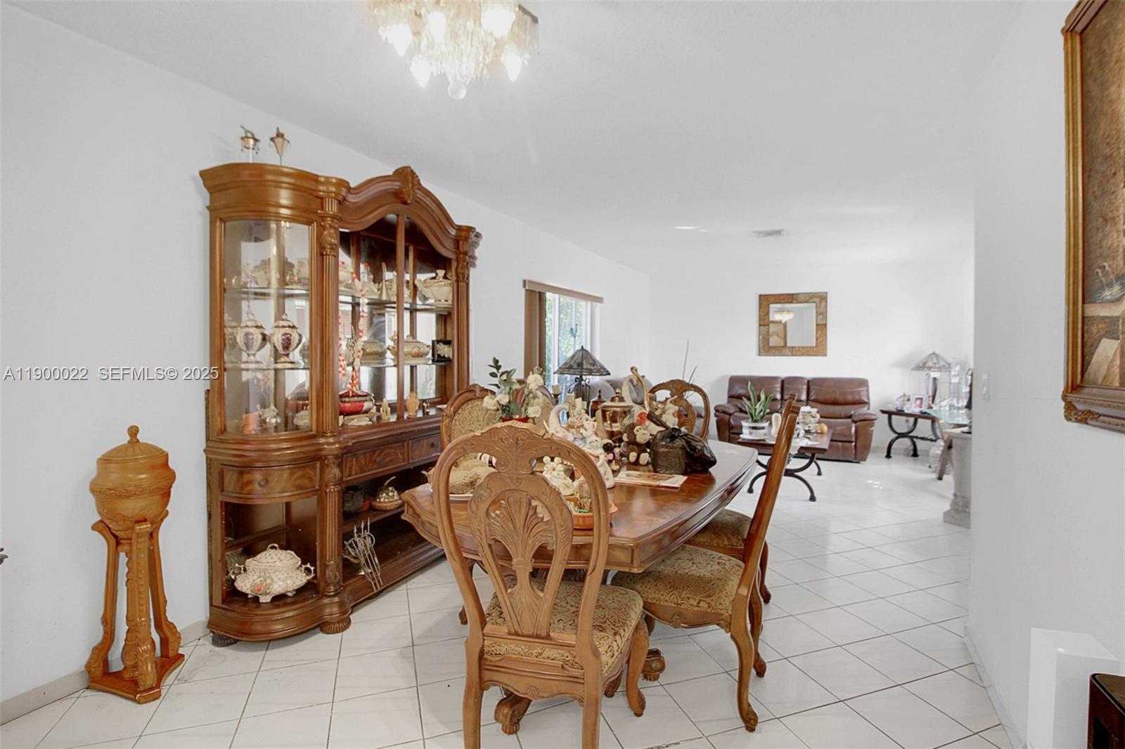 2711 Red Road Coral Gables, FL 33134 - Photo 21 of 33 a view of a dining room with furniture and chandelier