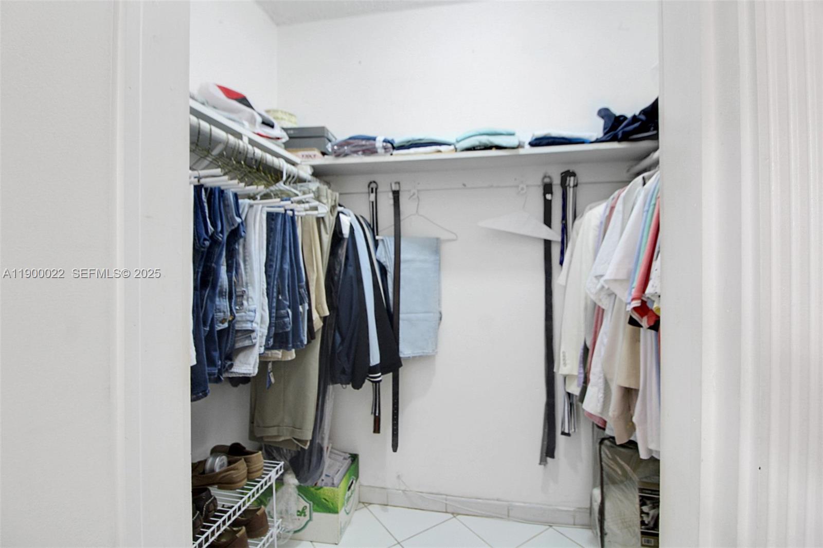 2711 Red Road Coral Gables, FL 33134 - Photo 25 of 33 a view of walk in closet with clothes and shoes