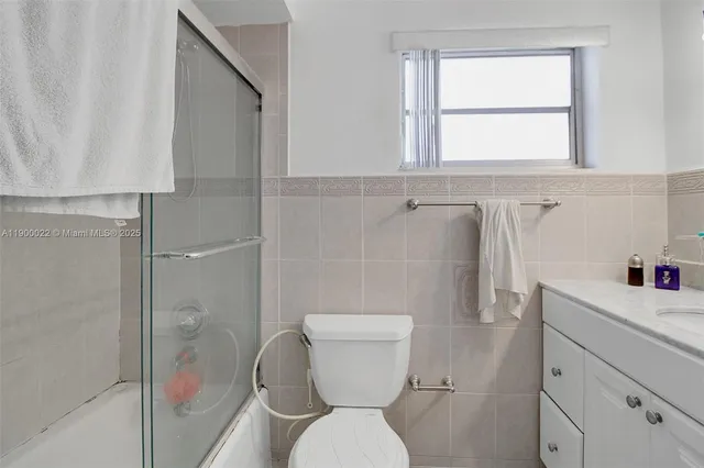 a bathroom with a toilet sink and shower
