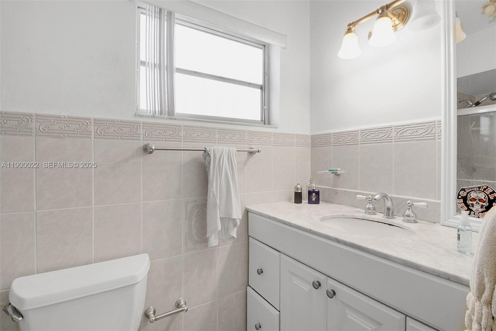 2711 Red Road Coral Gables, FL 33134 - Photo 28 of 33 a bathroom with a sink a toilet and a mirror
