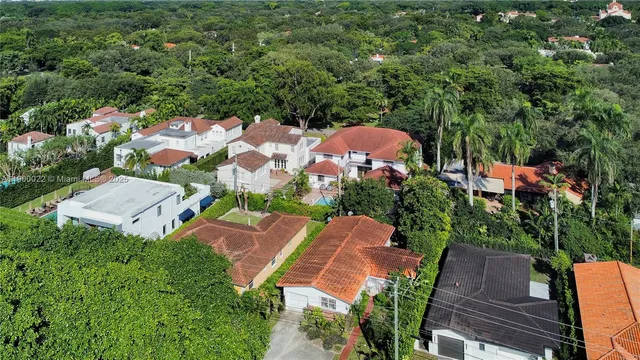 an aerial view of a house with garden space and street view