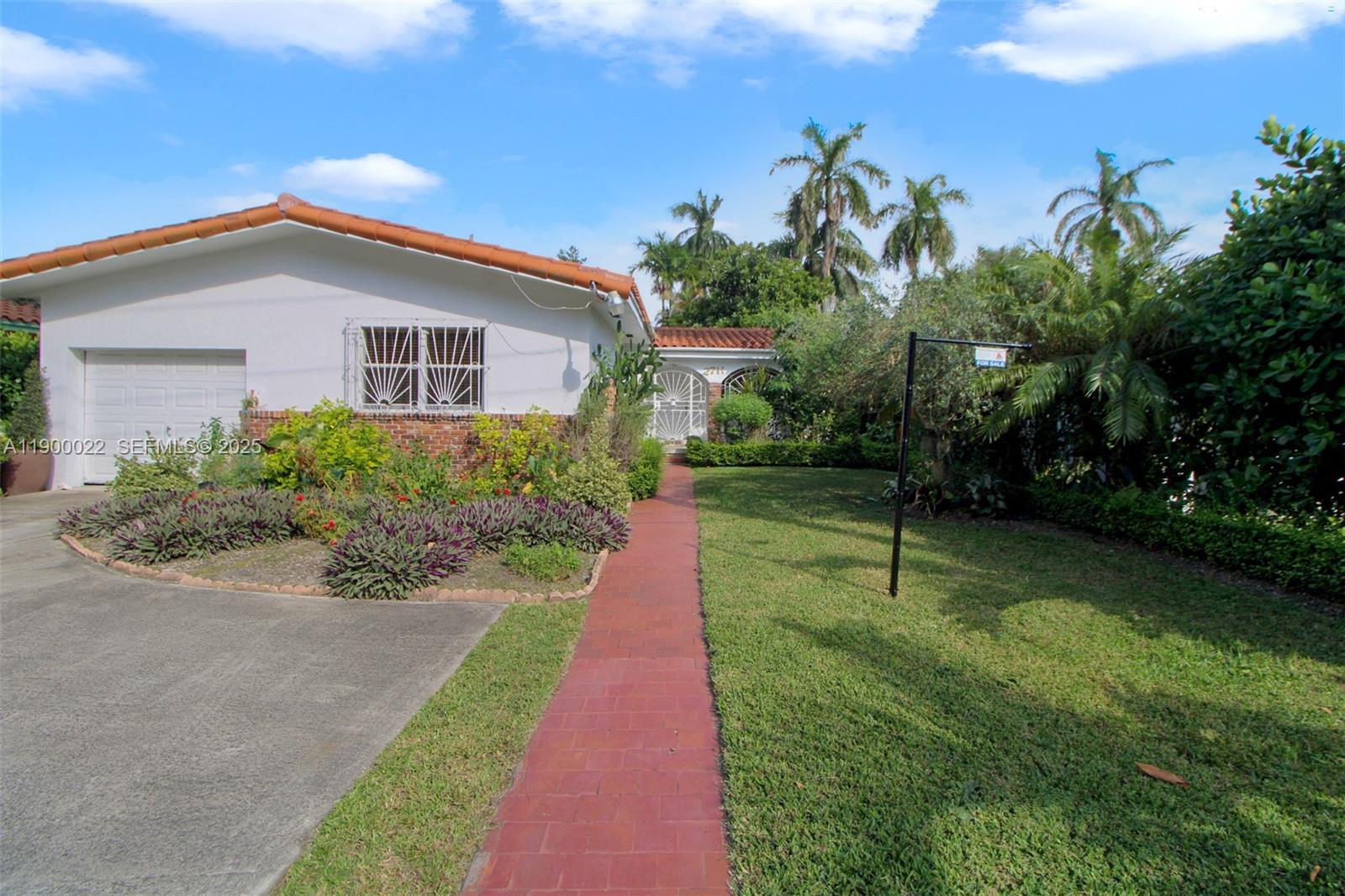 2711 Red Road Coral Gables, FL 33134 - Photo 10 of 33 a view of a house with yard and a garden