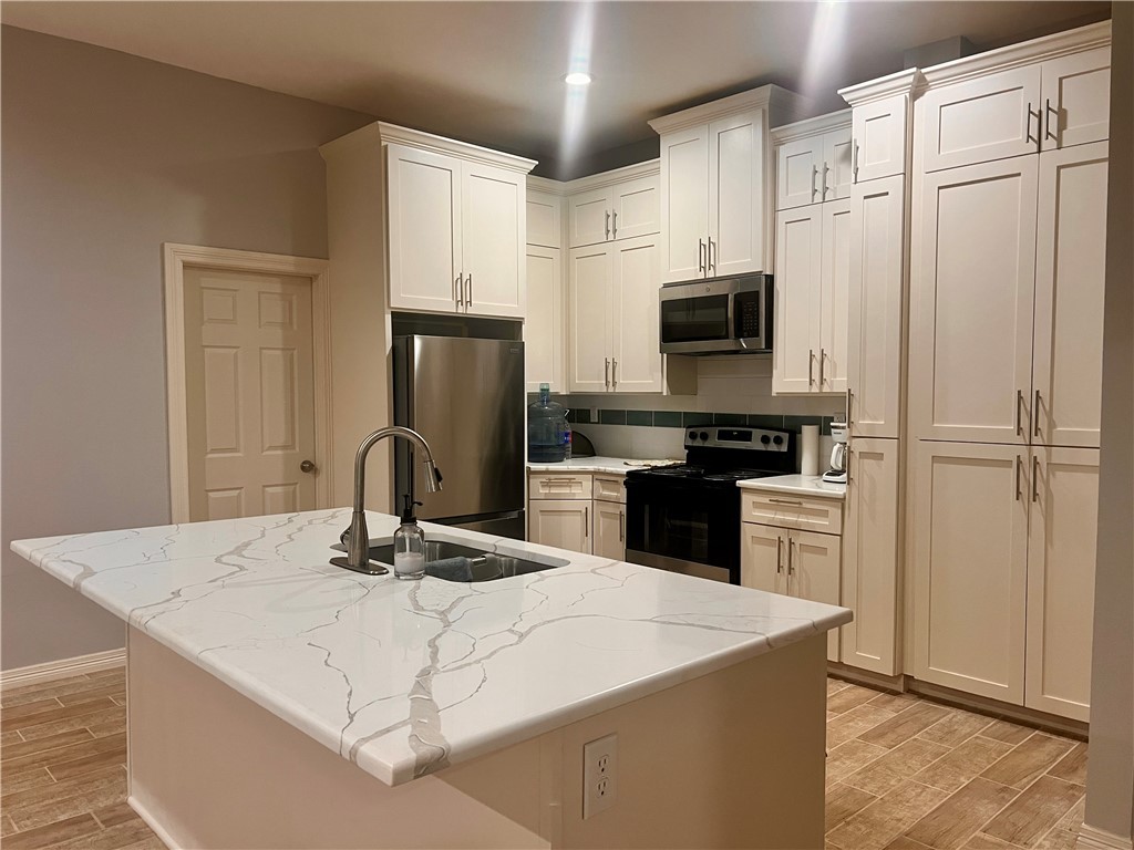 159 Lcr 904 Jewett, TX 75846 - Photo 2 of 20 a kitchen with kitchen island a counter appliances a sink and cabinets