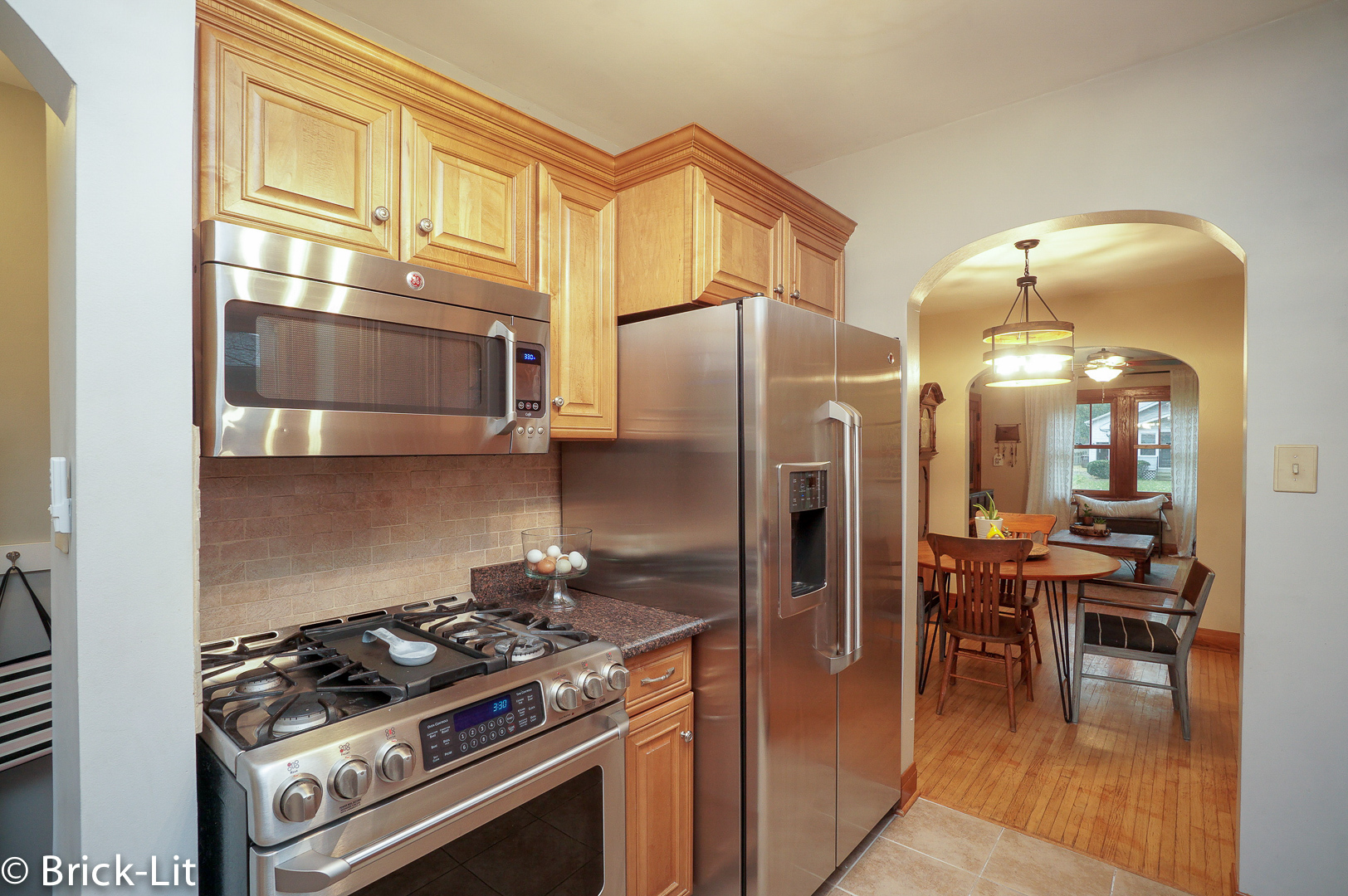 211 Gum Street New Lenox, IL 60451 - Photo 9 of 23 a kitchen with stainless steel appliances granite countertop a stove and a refrigerator