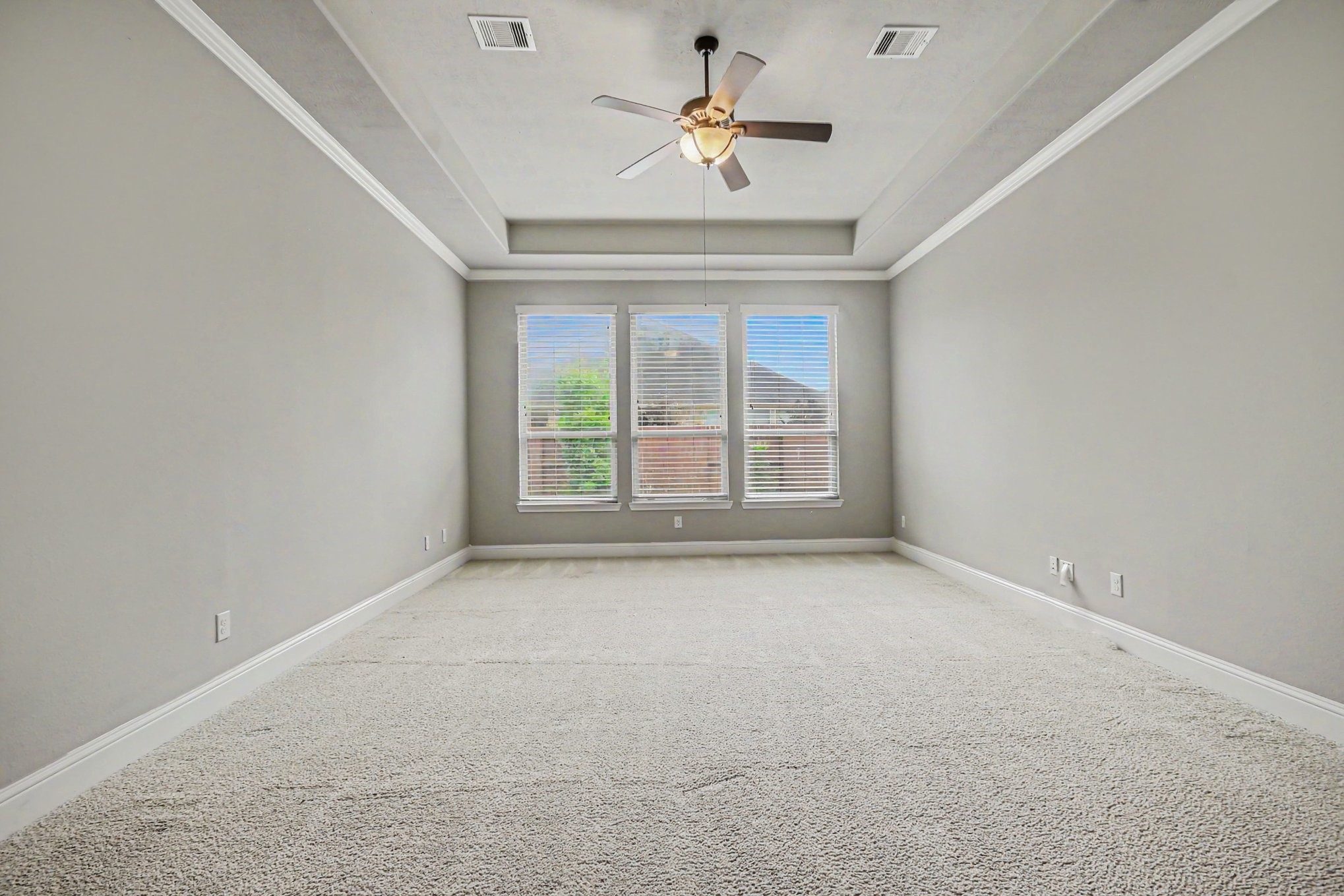 3310 Ralston Edge Lane Houston, TX 77059 - Photo 25 of 50 an empty room with a chandelier fan and windows