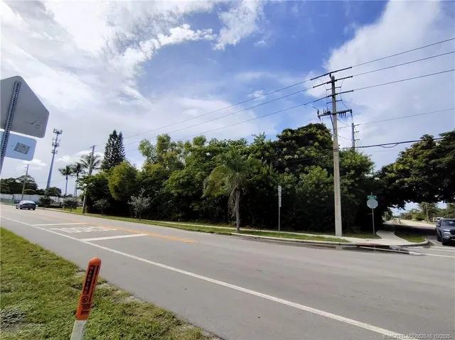a view of yard with swimming pool and trees in the background