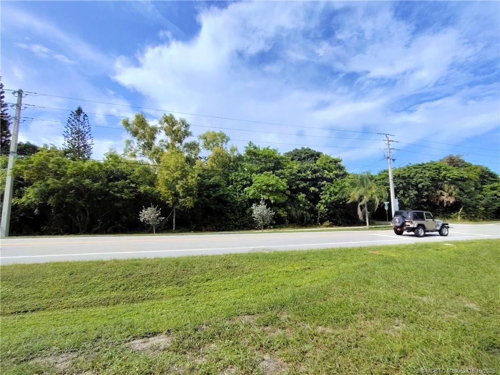 5470 Southeast Ebbtide Avenue Stuart, FL 34997 - Photo 8 of 40 a view of a garden with a building in the background