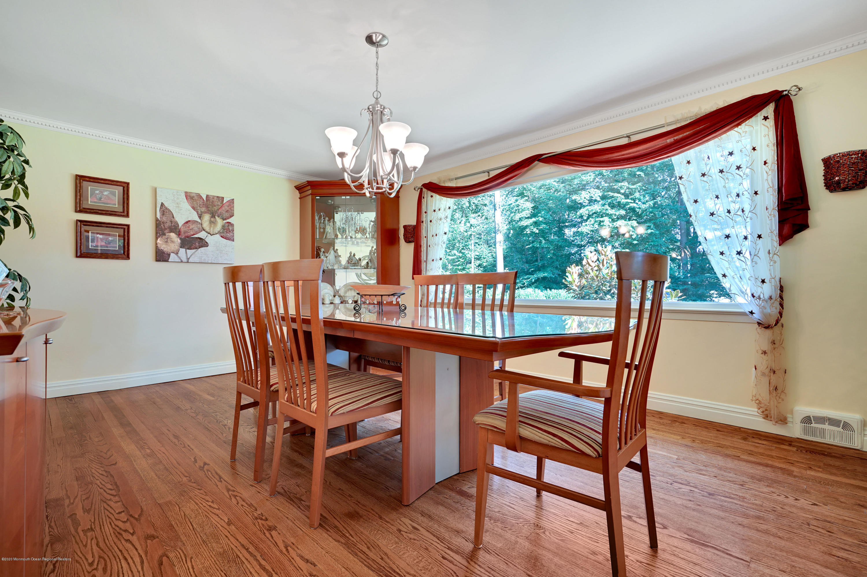 12 Crest Drive Colts Neck, NJ 07722 - Photo 32 of 69 a view of a dining room with furniture a chandelier and wooden floor