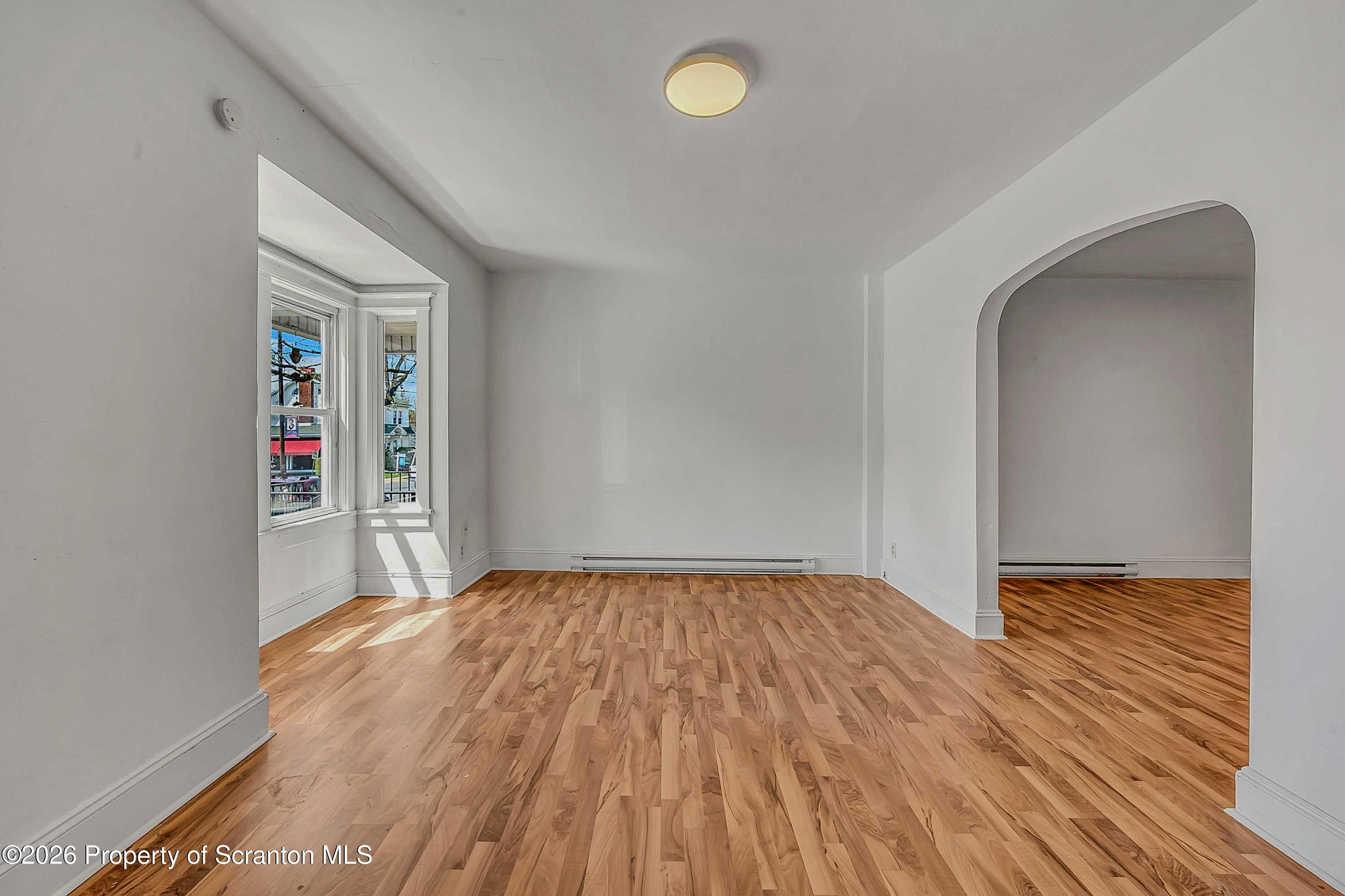 a view of a room with wooden floor and a sink