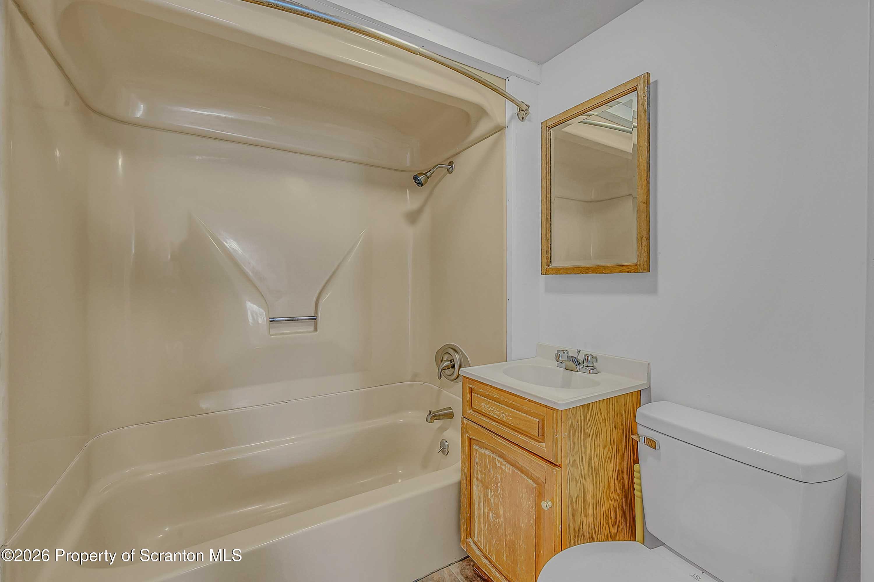 1807 Green Ridge Street Dunmore, PA 18509 - Photo 11 of 14 a bathroom with a toilet and a bathtub