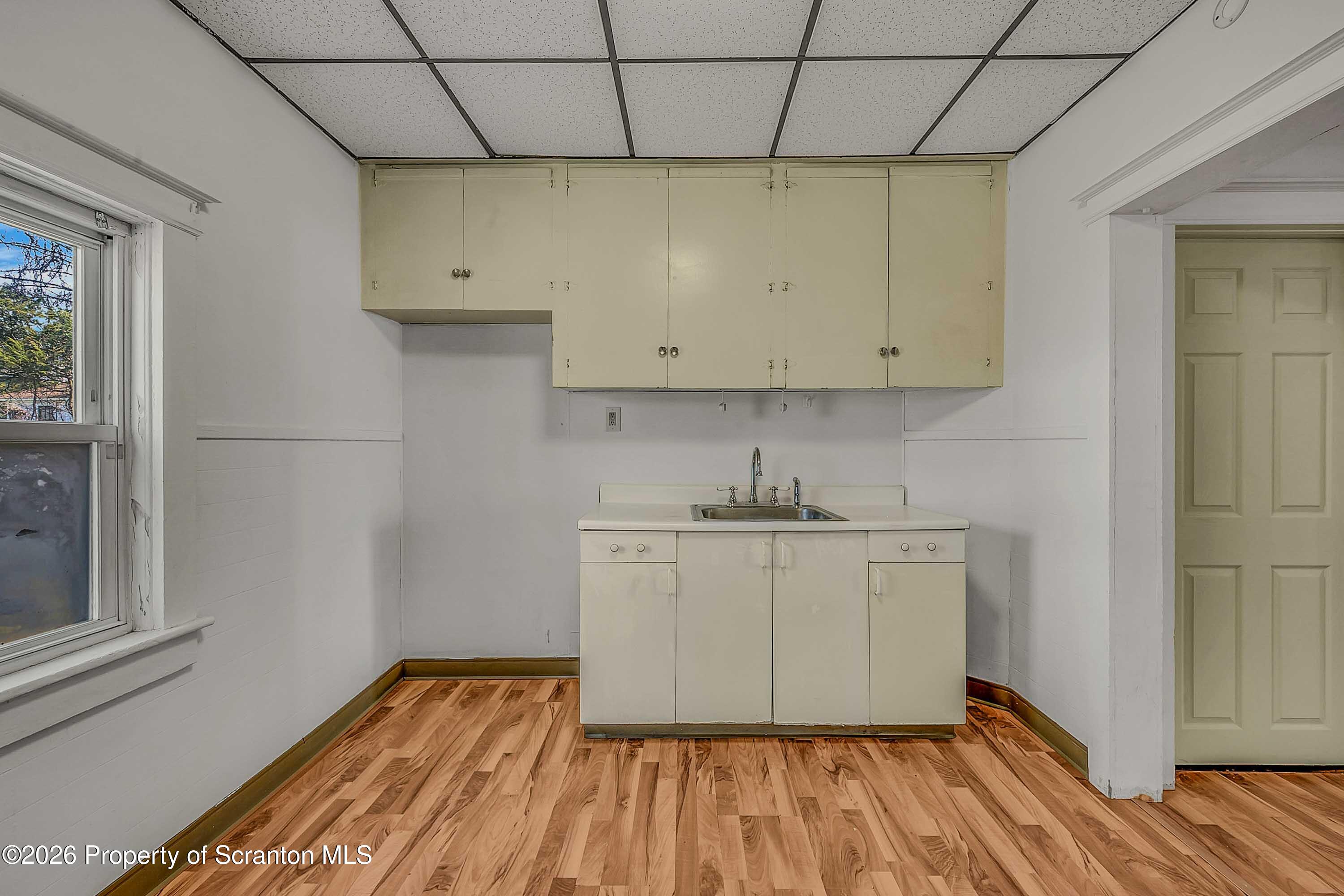 1807 Green Ridge Street Dunmore, PA 18509 - Photo 6 of 14 a room with wooden floor and cabinets