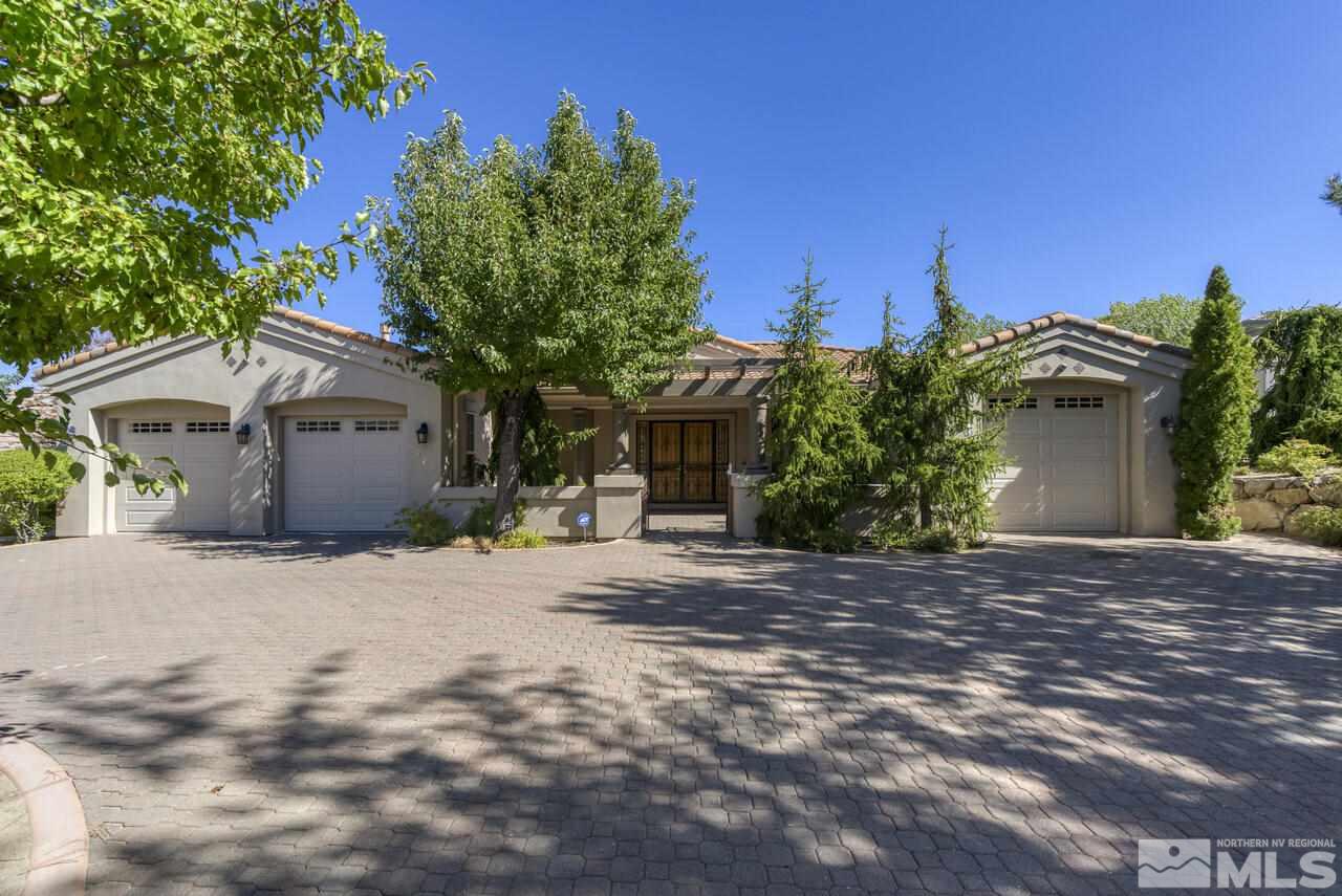 a front view of a house with a yard and a garage