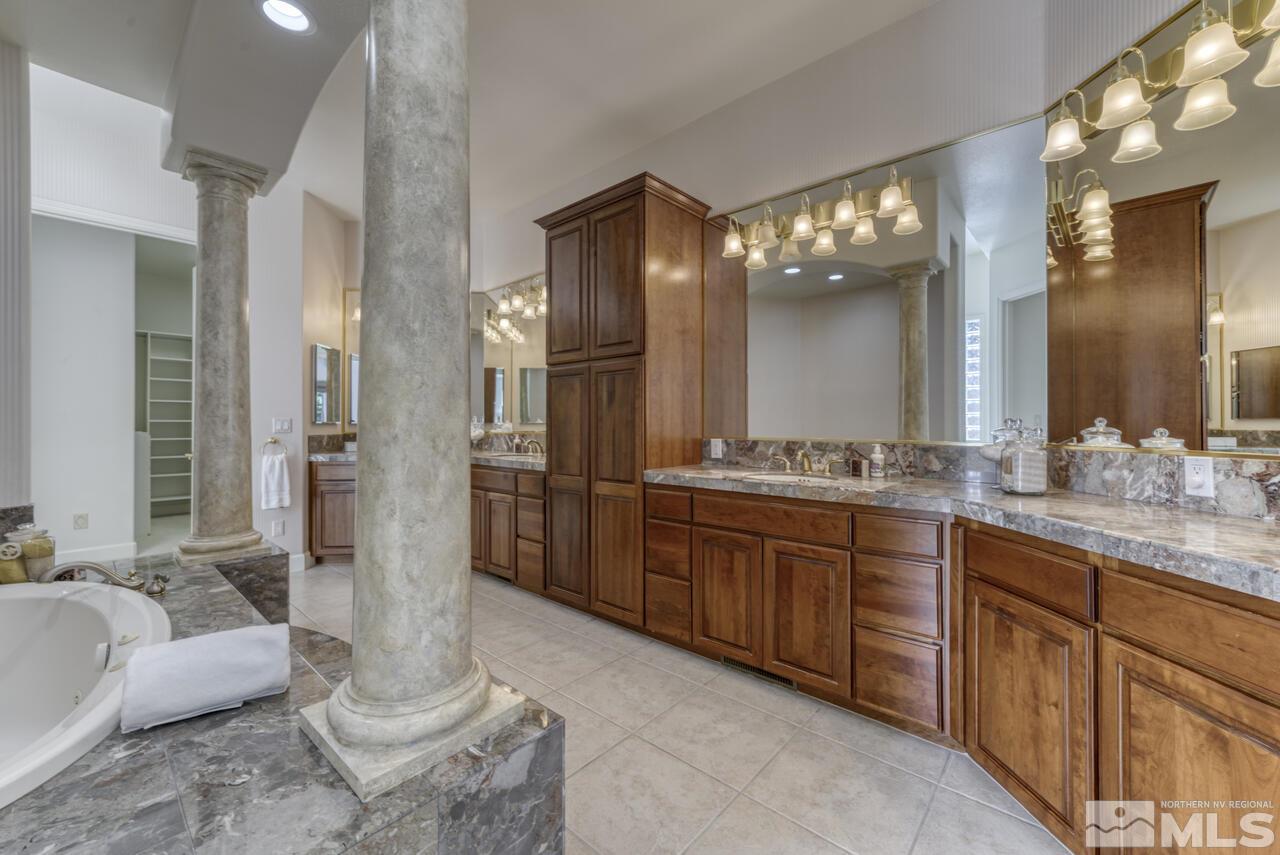 4565 Mountaingate Drive Reno, NV 89519 - Photo 16 of 25 a spacious bathroom with a double vanity sink and a mirror