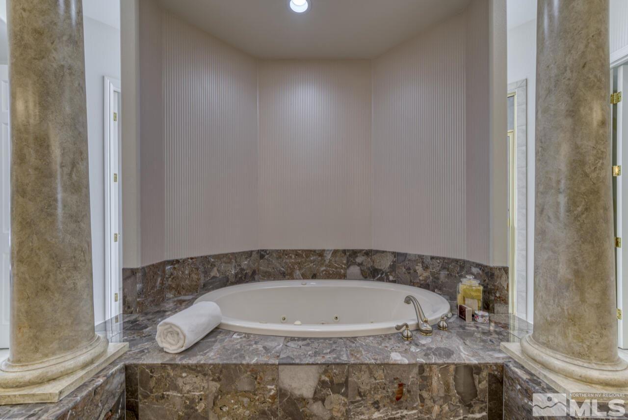 4565 Mountaingate Drive Reno, NV 89519 - Photo 17 of 25 a bathroom with a granite countertop bathtub and sink