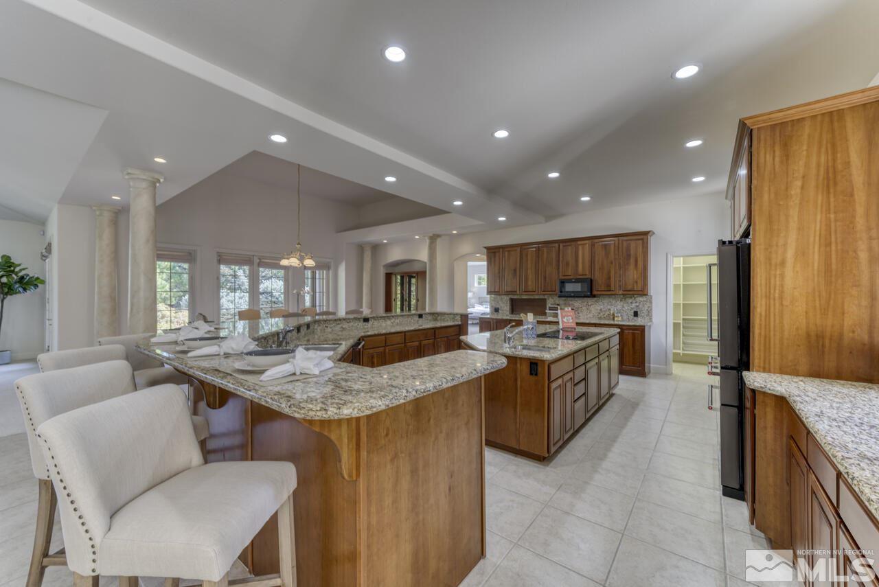 4565 Mountaingate Drive Reno, NV 89519 - Photo 8 of 25 a kitchen with a stove a sink a table and chairs