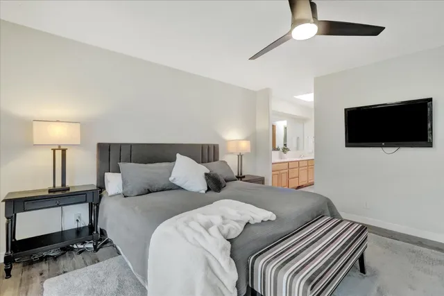 a view of a house with a small yard and sitting area