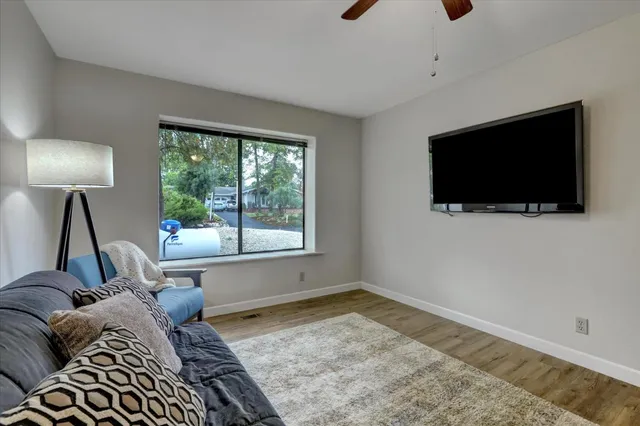 an aerial view of residential houses with outdoor space and trees