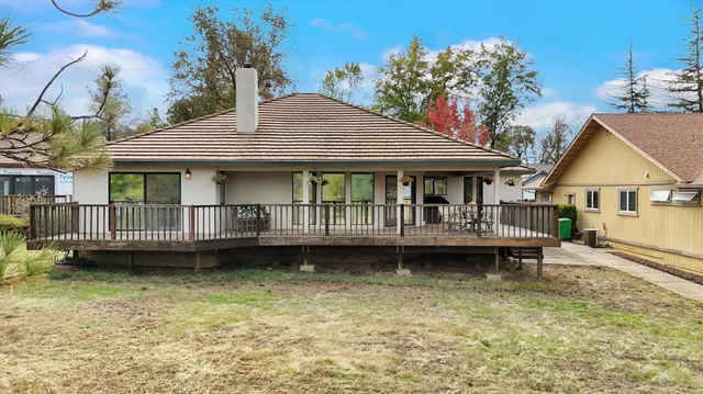 a view of a patio with a table chairs and a fire pit