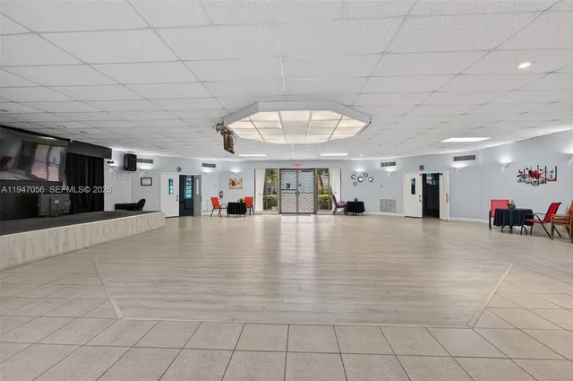 a view of a livingroom with furniture a flat screen tv and a fireplace