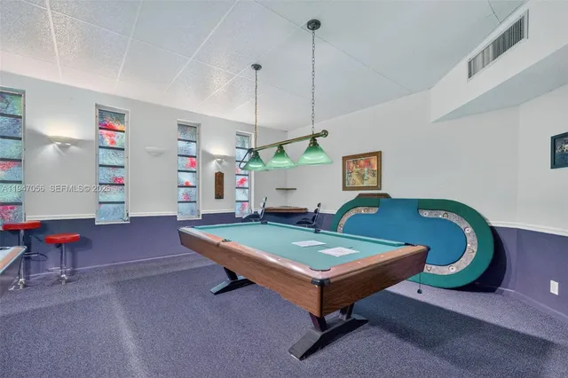 a living room with furniture and pool table