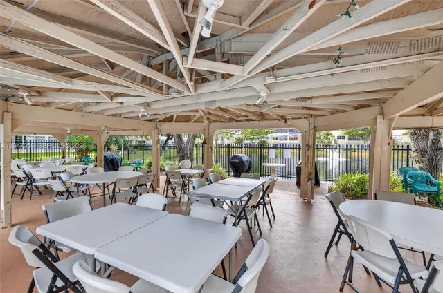 a view of a dining room with furniture water view and garden view