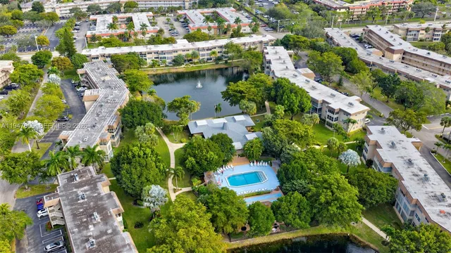 an aerial view of residential houses with outdoor space and swimming pool