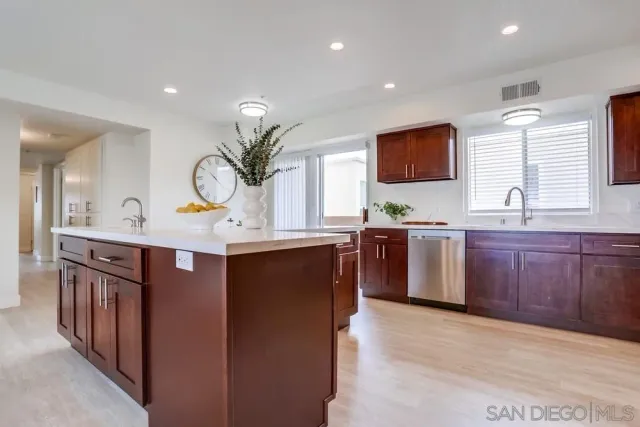 a kitchen with sink and refrigerator