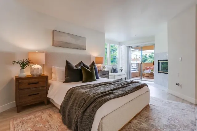 a bedroom with a bed and a potted plant