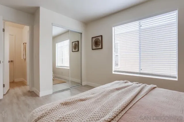 an aerial view of ocean and residential houses with outdoor space